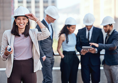 Buy stock photo Shot of a businesswoman wearing a hardhat while standing outside with her colleagues