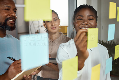 Buy stock photo Shot of a group of businesspeople brainstorming with sticky notes on a glass screen
