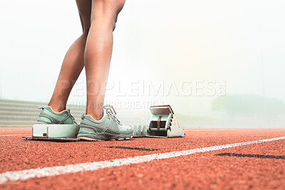 Buy stock photo Cropped shot of an unrecognizable sportswoman standing next to starting blocks on a running track