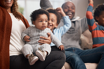 Buy stock photo Shot of a baby boy surrounded by his family at home