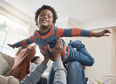 Buy stock photo Shot of a little boy having fun with his family at home
