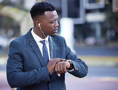Buy stock photo Shot of a young businessman standing in the street in the city