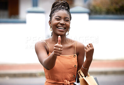 Buy stock photo Shot of a young female and showing a thumbs up sign in the city