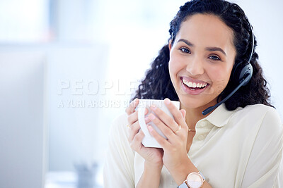 Buy stock photo Portrait of a young call centre agent drinking coffee while working in an office