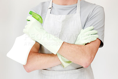 Buy stock photo Shot of an unrecognisable man holding cleaning spray and wearing rubber gloves