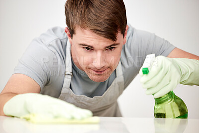 Buy stock photo Shot of a young man cleaning a table