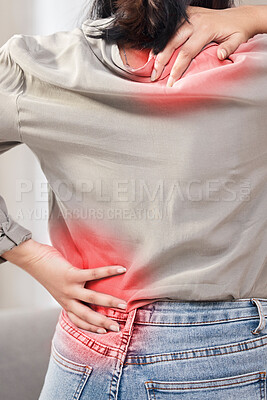 Buy stock photo Shot of an unrecognizable woman suffering from backache at home