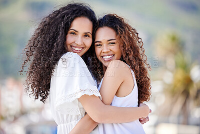 Buy stock photo Shot of two young women hugging outdoors