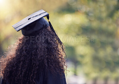 Buy stock photo Rearview shot of a young woman looking thoughtful on graduation day