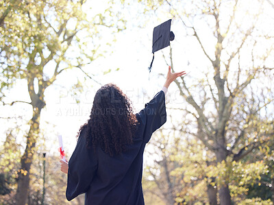 Buy stock photo Rearview shot of a young woman throwing her cap in the air on graduation day