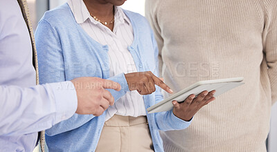 Buy stock photo Shot of a group of business people using a digital tablet during a meeting