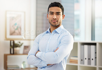 Buy stock photo Shot of a handsome young businessman in his office