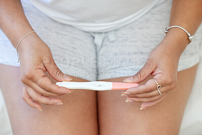 Buy stock photo Closeup shot of an unrecognisable woman taking a pregnancy test at home