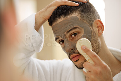 Buy stock photo Shot of a handsome young man giving himself a facial at home