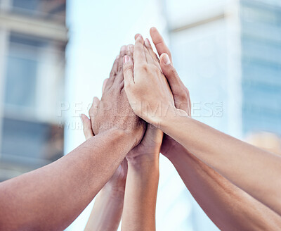Buy stock photo Shot of a group of unrecognizable people giving each other a high five in the city