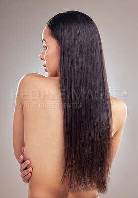 Buy stock photo Shot of a young woman standing alone in the studio and posing