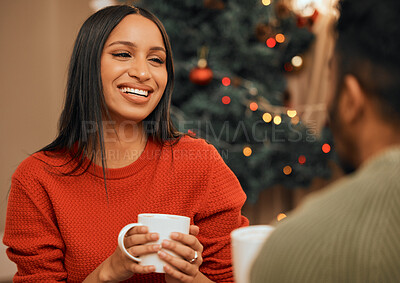 Buy stock photo Shot of a young woman having a warm drink while bonding with her partner at home