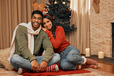 Buy stock photo Portrait of a young couple celebrating Christmas at home