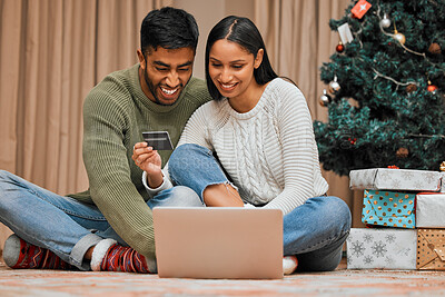 Buy stock photo Shot of a young couple using a laptop and credit card during Christmas at home