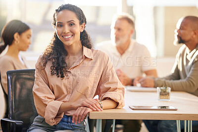 Buy stock photo Portrait of a young businesswoman at the office sitting in front of her colleagues having a meeting in the background
