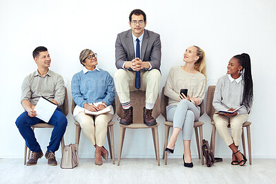 Buy stock photo Shot of a group of people waiting to be interviewed for a job at a modern office