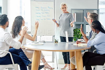 Buy stock photo Shot of a mature businesswoman giving a presentation to her colleagues in an office