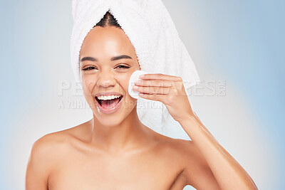 Buy stock photo Shot of a young woman doing skincare against a blue background
