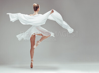Buy stock photo Full length shot of an unrecognisable ballerina dancing alone in the studio