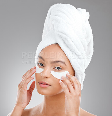 Buy stock photo Shot of an attractive young woman wearing an under eye patch against a studio background