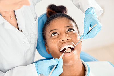 Buy stock photo Shot of a young female patient having her teeth examined