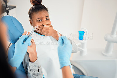 Buy stock photo Shot of a young woman looking afraid at the dentists office