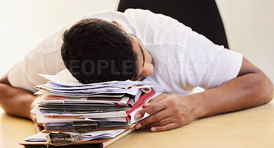 Buy stock photo Shot of an unrecognisable man asleep on a stack of paperwork while working from home