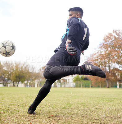Buy stock photo Shot of a young man playing soccer on a field