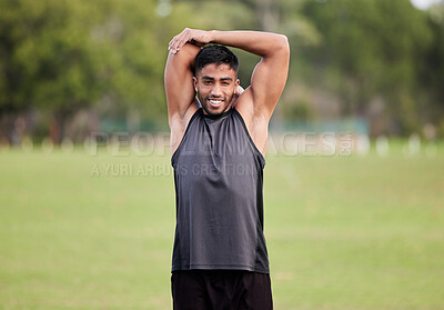 Buy stock photo Shot of a handsome young man  stretching before his outdoor run