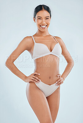Buy stock photo Shot of an attractive young woman standing alone in the studio and posing in her underwear