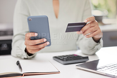 Buy stock photo High angle shot of an unrecognizable businesswoman using her cellphone while holding a credit card in the office