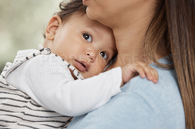 Buy stock photo Shot of a mother holding her baby at home