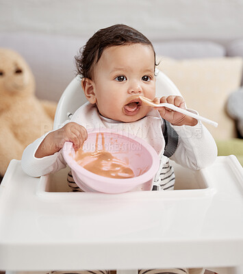 Buy stock photo Shot of a baby eating a meal at home