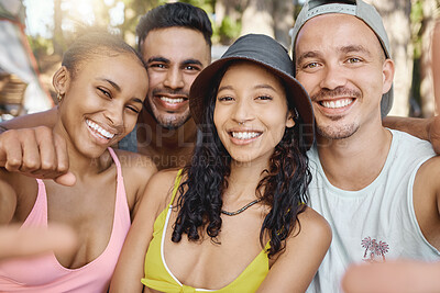 Buy stock photo Shot of a diverse group of friends standing together and taking a selfie while camping in the woods