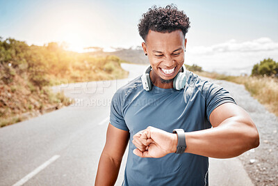 Buy stock photo Shot of a man using his watch to track his pulse while out for a workout