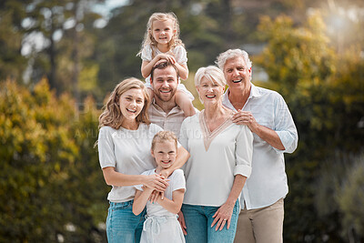 Buy stock photo Portrait of a smiling multi generation caucasian family standing close together in the garden at home. Happy adorable girls bonding with their mother, father, grandfather and grandmother in a backyard