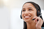 One young hispanic happy and cheerful female call center agent wearing a headset and working in customer service at work. Face of a hispanic woman answering calls working at a call center