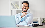 Portrait of one confident young mixed race businessman working on laptop at desk in an office. Ambitious motivated entrepreneur and leader dedicated to success with hard work. Boss working in startup