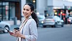 Businesswoman listening to music in the city. Businesswoman listening to music on her cellphone with earphones. Businesswoman drinking coffee in the city. Portrait of corporate businesswoman outside