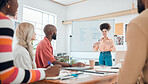 Group of diverse businesspeople having a meeting in a modern office at work. Young hispanic businesswoman with a curly afro talking while doing a presentation of an idea on a whiteboard in a boardroom with colleagues. Businesspeople planning together