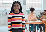 Young cheerful african american businesswoman standing in an office. Confident black female manager smiling and standing at work