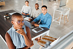 Group of diverse businesspeople having a meeting in an office at work. Young focused african american businesswoman thinking of an idea on a whiteboard in a boardroom with colleagues. Businesspeople planning together
