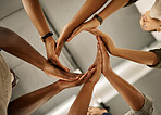 Closeup of hands of group of businesspeople in a circle. Diverse designers united in support. Fashion designer collaborating. Entrepreneurs with their hands flowing in a circle.