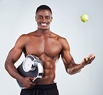 Portrait of a smiling African American fitness model posing topless with an apple and a scale. Happy black male athlete isolated on grey copyspace positive about his healthy diet