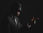 Dapper and confident young man dressed in formal attire against a dark background. Handsome african american male looking stylish and sophisticated isolated on black. Looking very classy and debonair